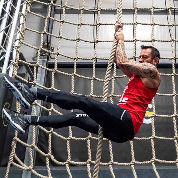 man climbing legless in a rope