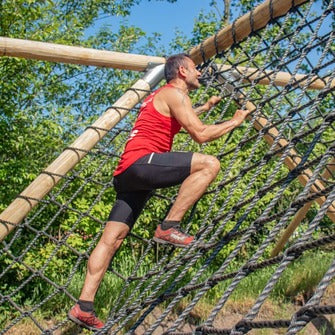 man in a climbing net