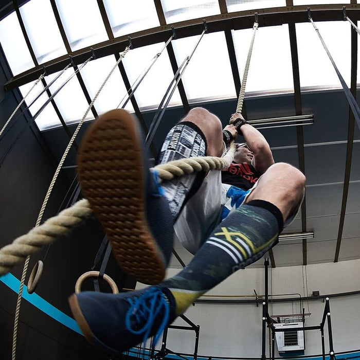 man climbing in a rope indoor